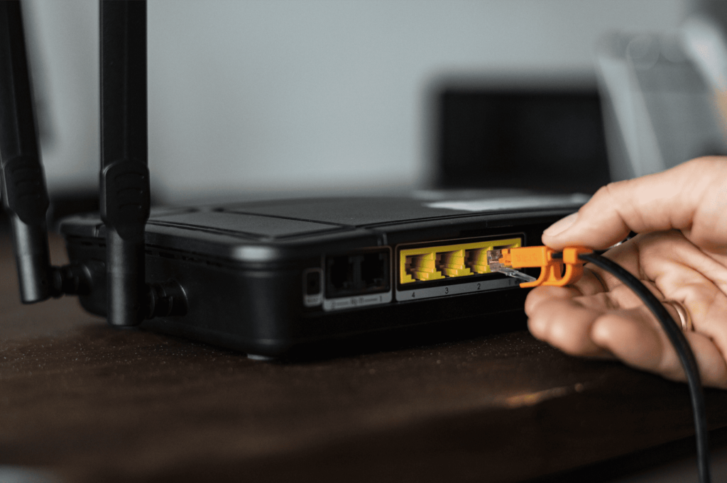 man-plugging-cable-to-router